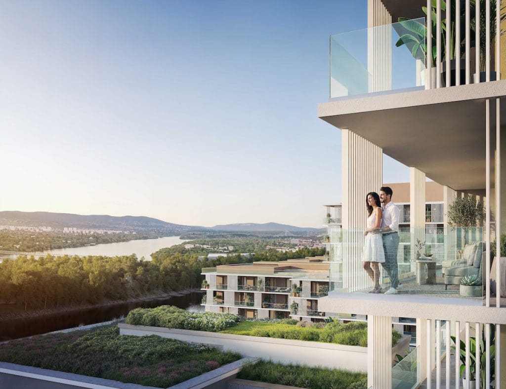 Cordia lakópark látványterve. A teraszon egy pár gyönyörködik a kilátásban.